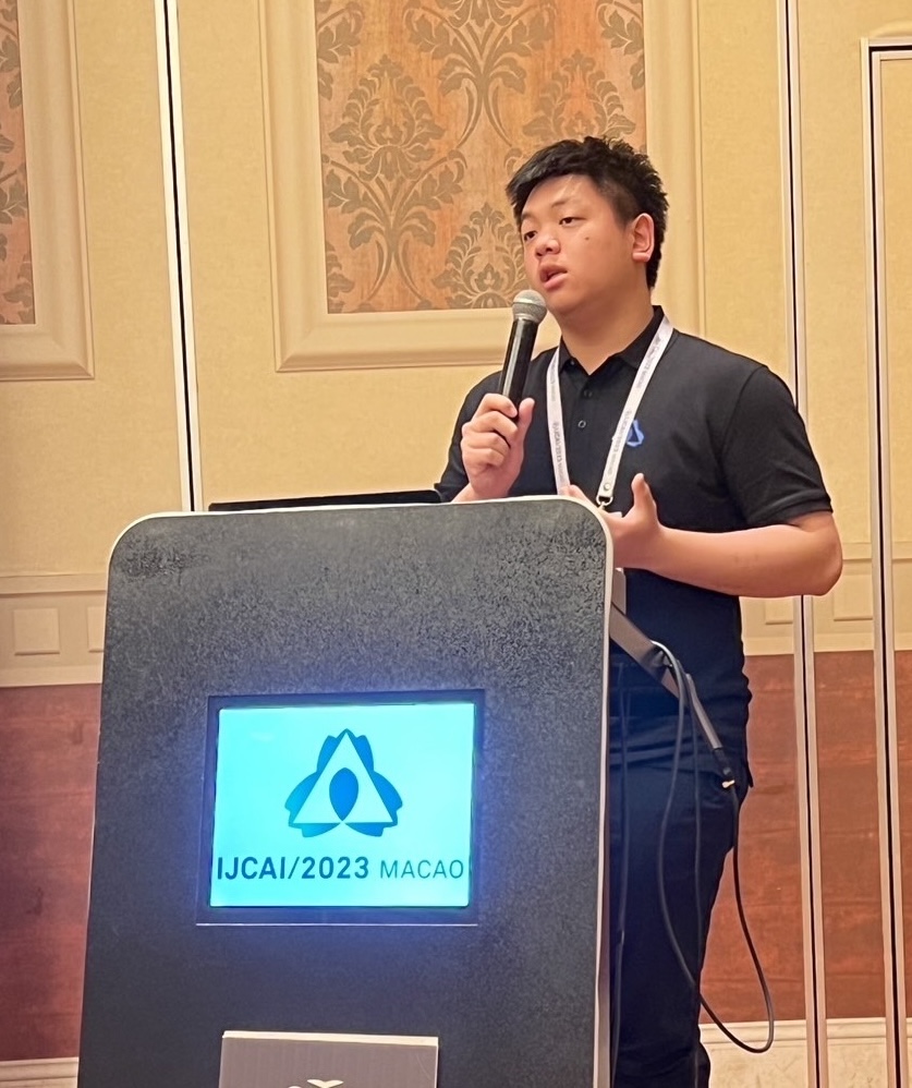 Me presenting at IJCAI 2023